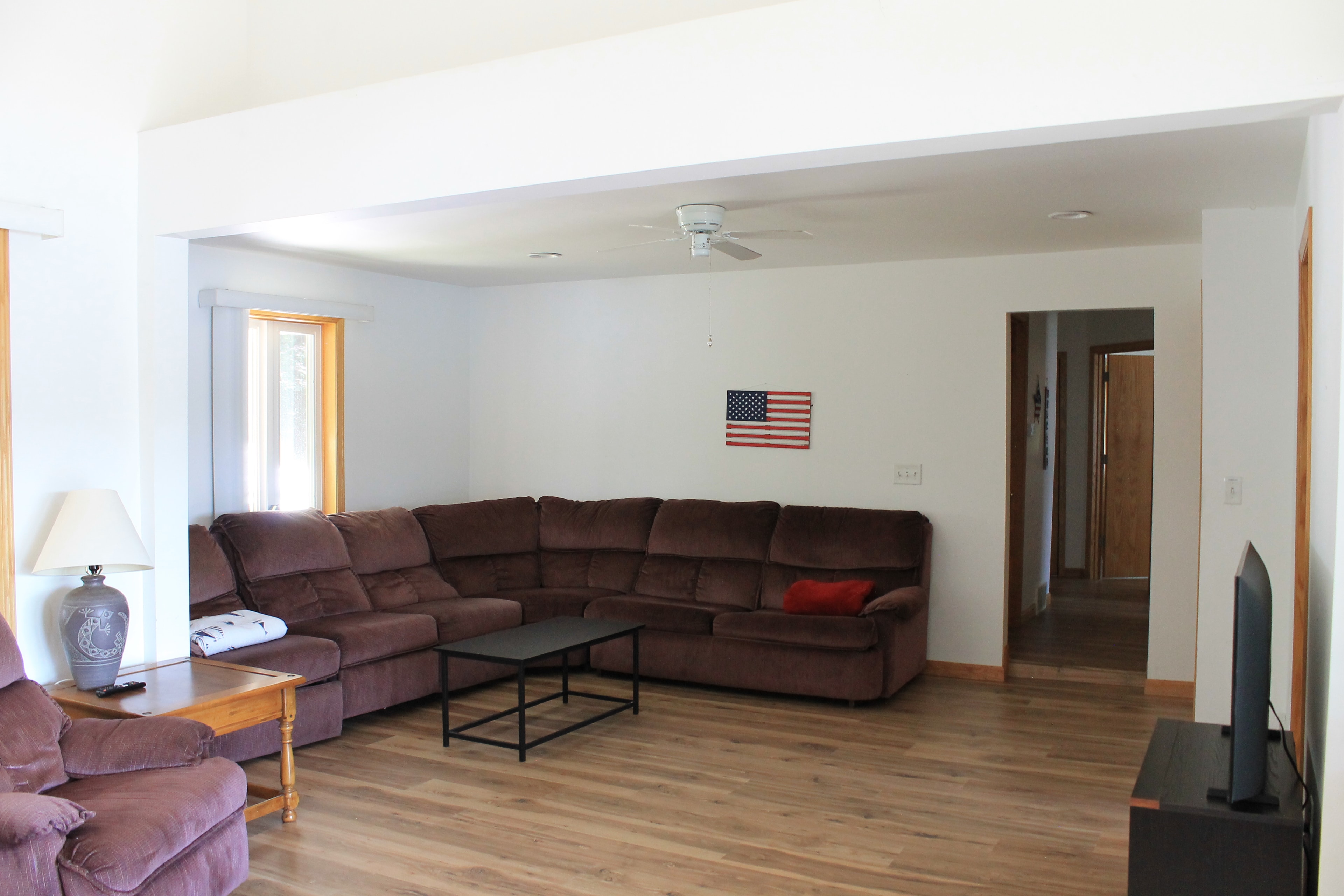Spacious living room with sectional sofa and hardwood floors